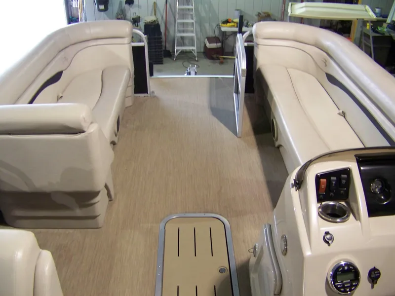 Slide: The Image of 2018 Bennington 21SL pontoon boat interior with beige seating and control panel. - 6
