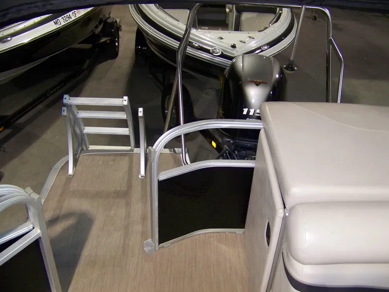 Slide: The Image of 2018 Bennington 21SL pontoon boat interior with seating and motor view. - 8