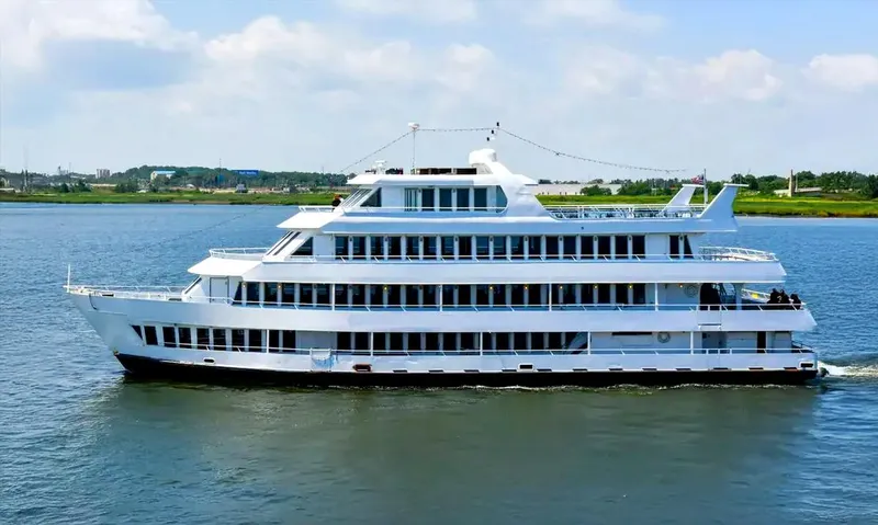 The Image of Blount 130 Dinner Cruise ship from 1979 sailing on a calm river. - 0