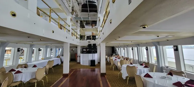 Slide: The Image of Elegant dining area on Blount 130 Dinner Cruise ship, 1979, with white tablecloths and panoramic windows. - 10
