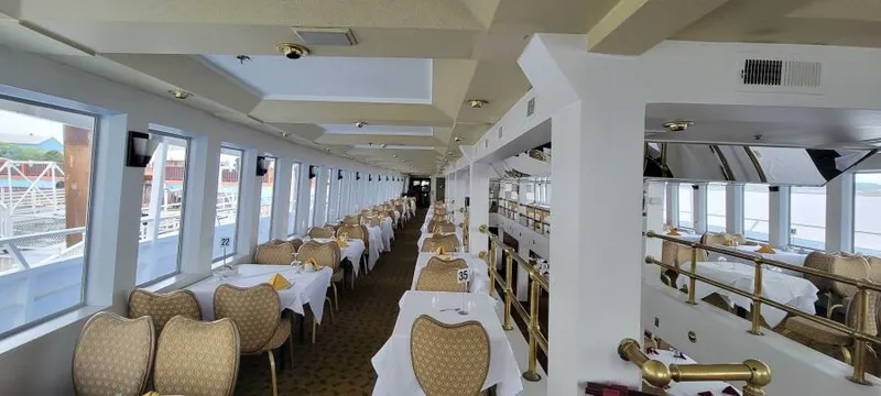 Slide: The Image of Elegant dining area on Blount 130 Dinner Cruise, 1979 model, with panoramic windows and set tables. - 13