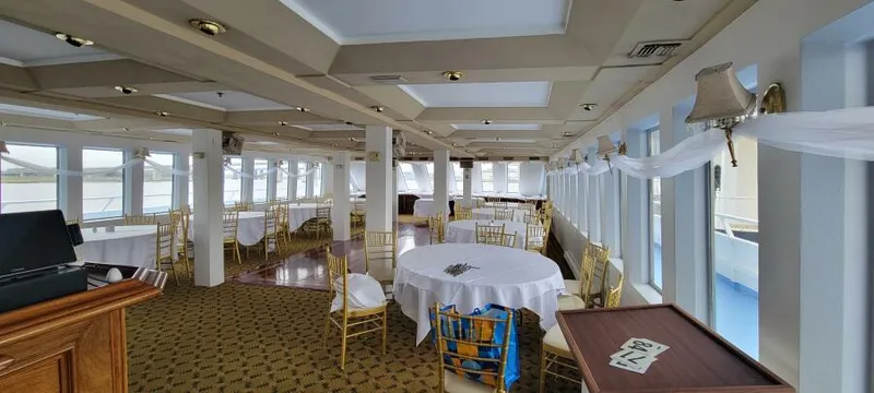 Slide: The Image of Elegant dining area on Blount 130 Dinner Cruise, 1979, with white tablecloths and gold chairs. - 15