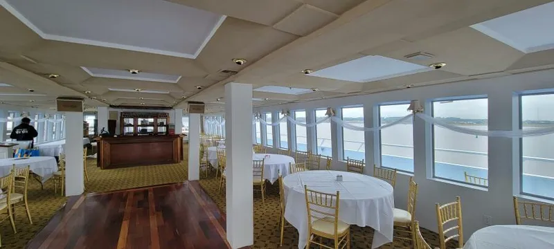 Slide: The Image of Elegant dining area on Blount 130 Dinner Cruise, 1979, with round tables and panoramic windows. - 16