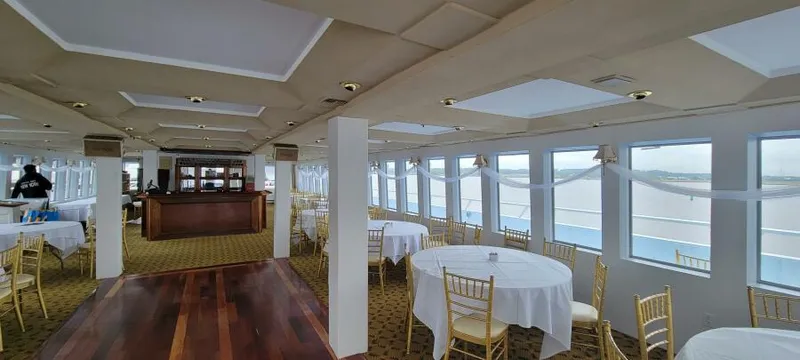 Slide: The Image of Elegant dining area on Blount 130 Dinner Cruise, 1979, with round tables and panoramic windows. - 17