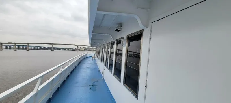 Slide: The Image of Side view of Blount 130 Dinner Cruise ship, 1979, with blue deck and river backdrop. - 4