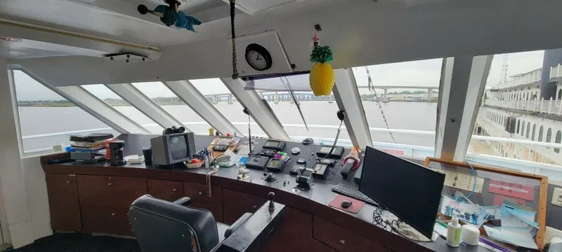 Slide: The Image of Bridge of 1979 Blount 130 Dinner Cruise ship with navigation equipment and river view. - 7