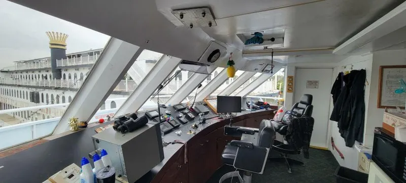Slide: The Image of Interior of Blount 130 Dinner Cruise ship's bridge, showcasing navigation equipment and panoramic windows. - 8