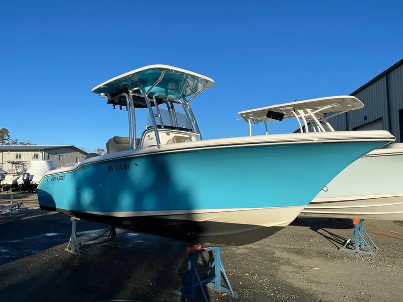 Slide: The Image of 2023 Key West 239 FS boat in vibrant blue, displayed outdoors on stands. - 2
