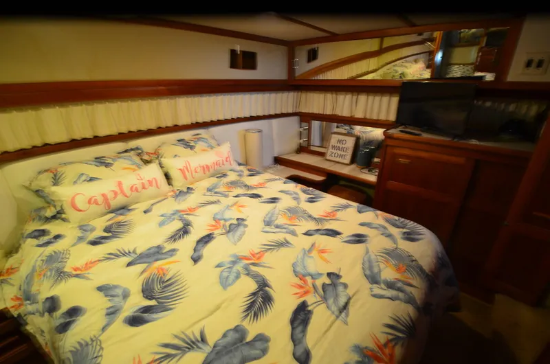 Slide: The Image of Cozy bedroom in 1988 Carver 4207 Aft Cabin MY with tropical bedding and wooden accents. - 10