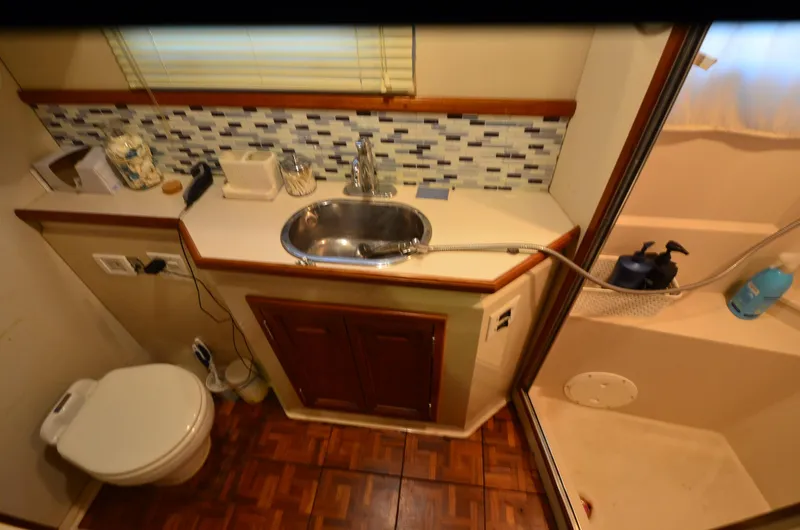Slide: The Image of 1988 Carver 4207 Aft Cabin MY bathroom with sink, toilet, and shower. - 11
