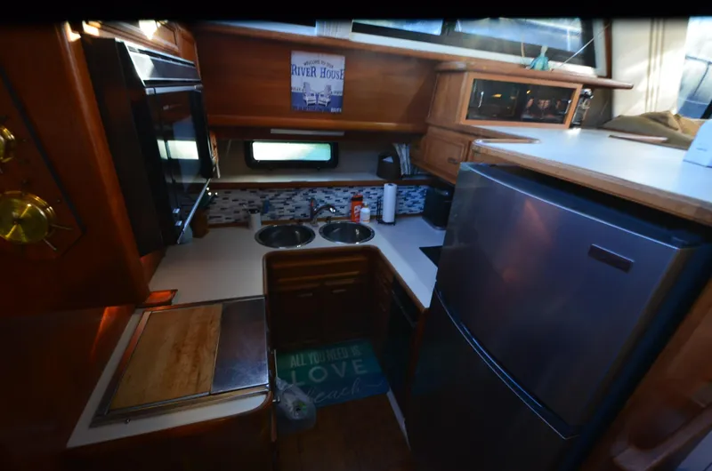 Slide: The Image of 1988 Carver 4207 Aft Cabin MY kitchen with modern appliances and wood cabinetry. - 13