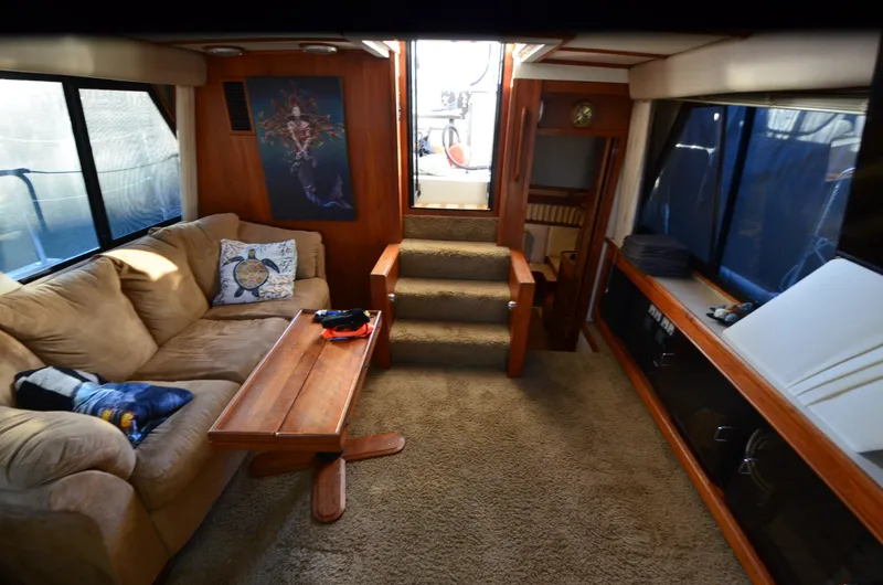 Slide: The Image of 1988 Carver 4207 Aft Cabin MY interior with cozy seating and wooden accents. - 14