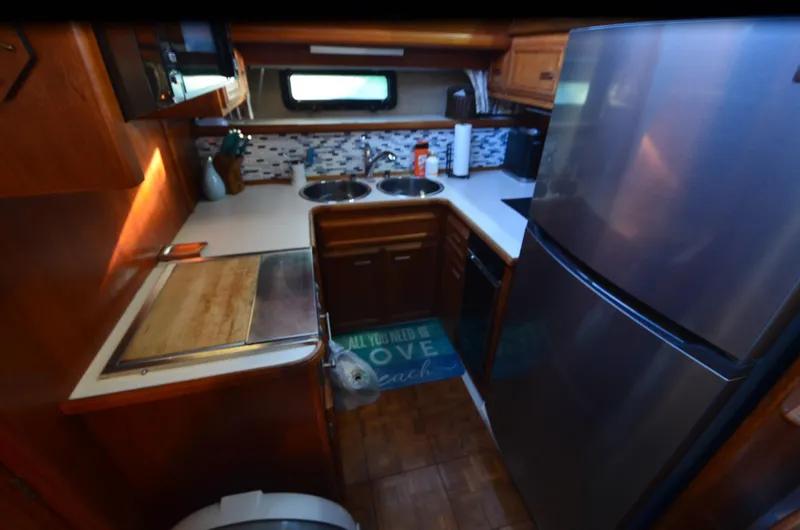 Slide: The Image of 1988 Carver 4207 Aft Cabin MY kitchen with modern appliances and wooden cabinetry. - 18