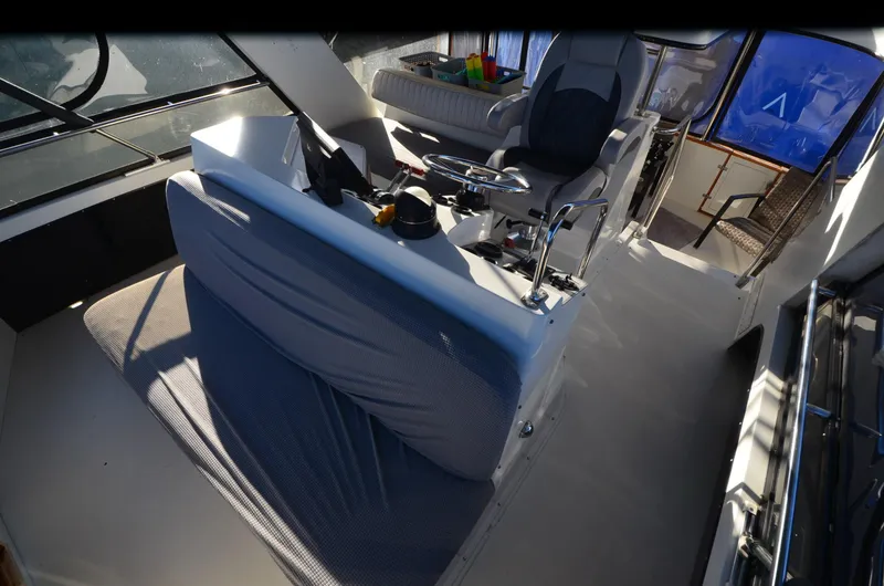 Slide: The Image of 1988 Carver 4207 Aft Cabin MY interior with helm and seating area. - 21