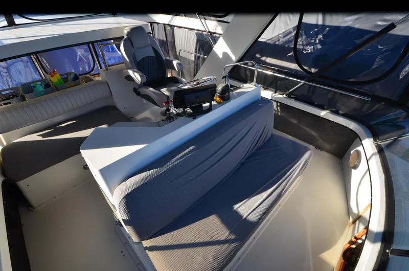 Slide: The Image of 1988 Carver 4207 Aft Cabin MY interior with helm, seating, and navigation equipment. - 22