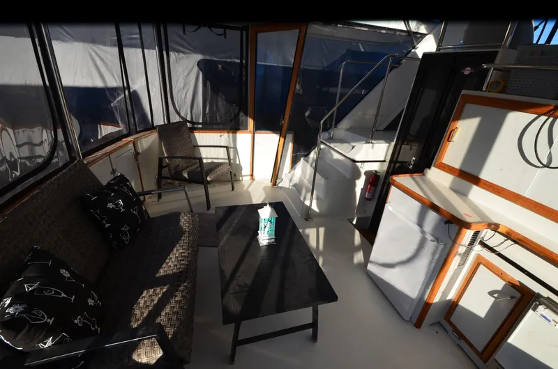 Slide: The Image of 1988 Carver 4207 Aft Cabin MY interior with seating, table, and kitchenette. - 24