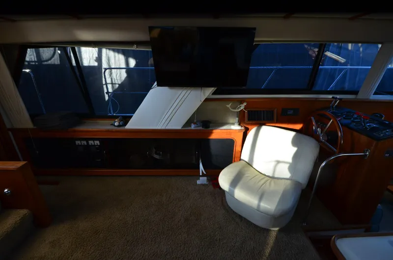 Slide: The Image of Interior of 1988 Carver 4207 Aft Cabin MY with chair and TV. - 25
