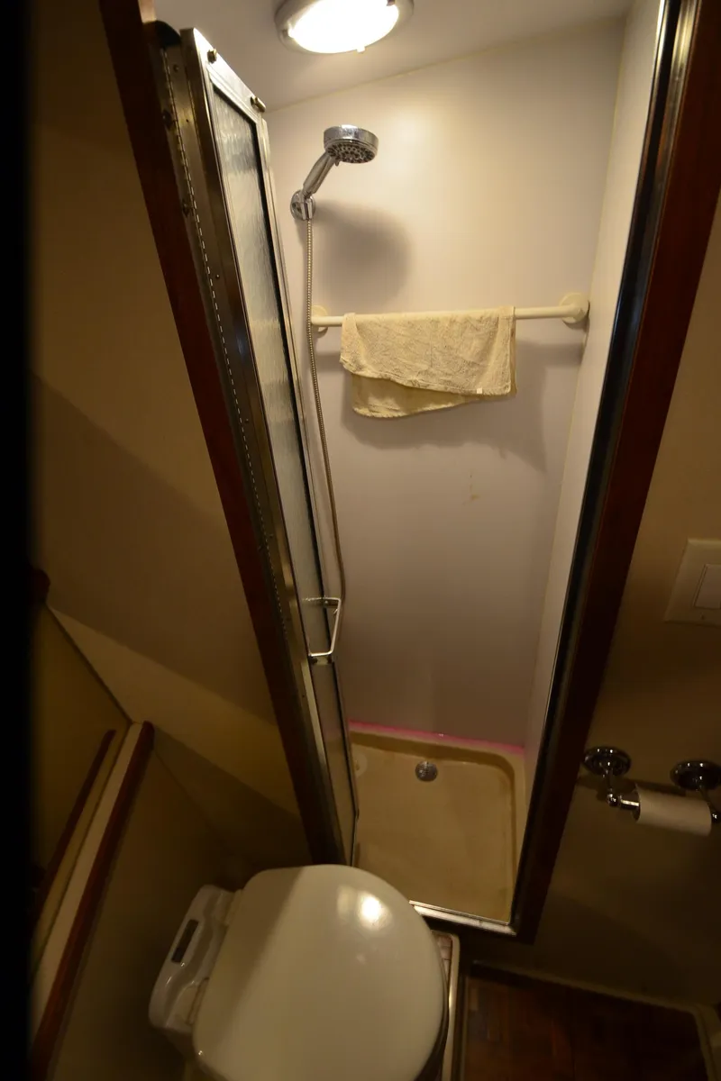 Slide: The Image of Compact bathroom in 1988 Carver 4207 Aft Cabin MY with shower and toilet. - 27