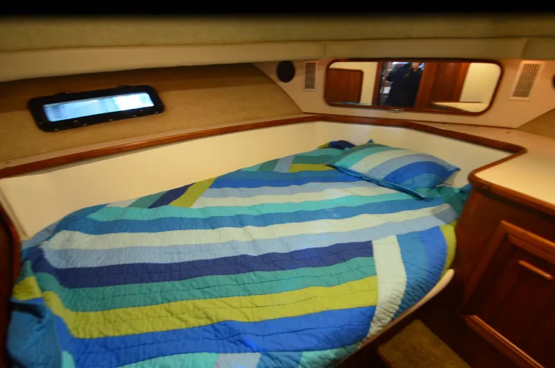 Slide: The Image of 1988 Carver 4207 Aft Cabin MY interior with colorful bedspread in cozy cabin. - 28