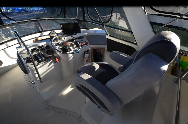 Slide: The Image of 1988 Carver 4207 Aft Cabin MY helm with steering wheel and captain's chair. - 3
