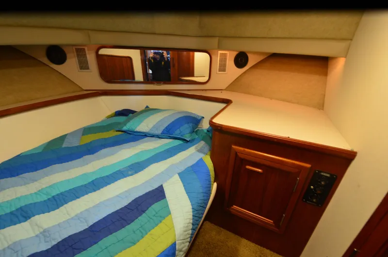 Slide: The Image of Cozy cabin interior of 1988 Carver 4207 Aft Cabin MY with striped bedding. - 30