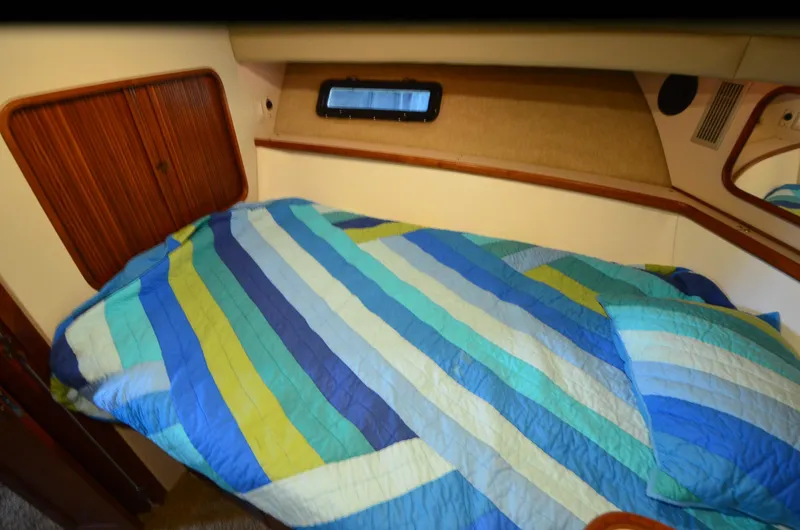 Slide: The Image of 1988 Carver 4207 Aft Cabin MY interior with colorful striped bedding. - 31