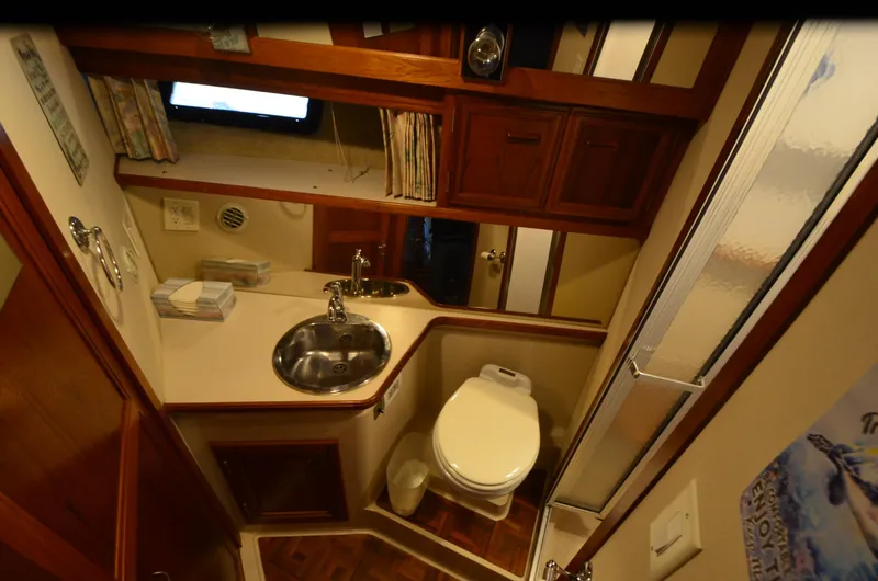 Slide: The Image of 1988 Carver 4207 Aft Cabin MY bathroom with sink, toilet, and shower. - 32