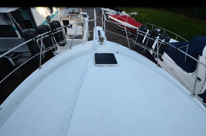 Slide: The Image of 1988 Carver 4207 Aft Cabin MY boat deck view, surrounded by other boats. - 33