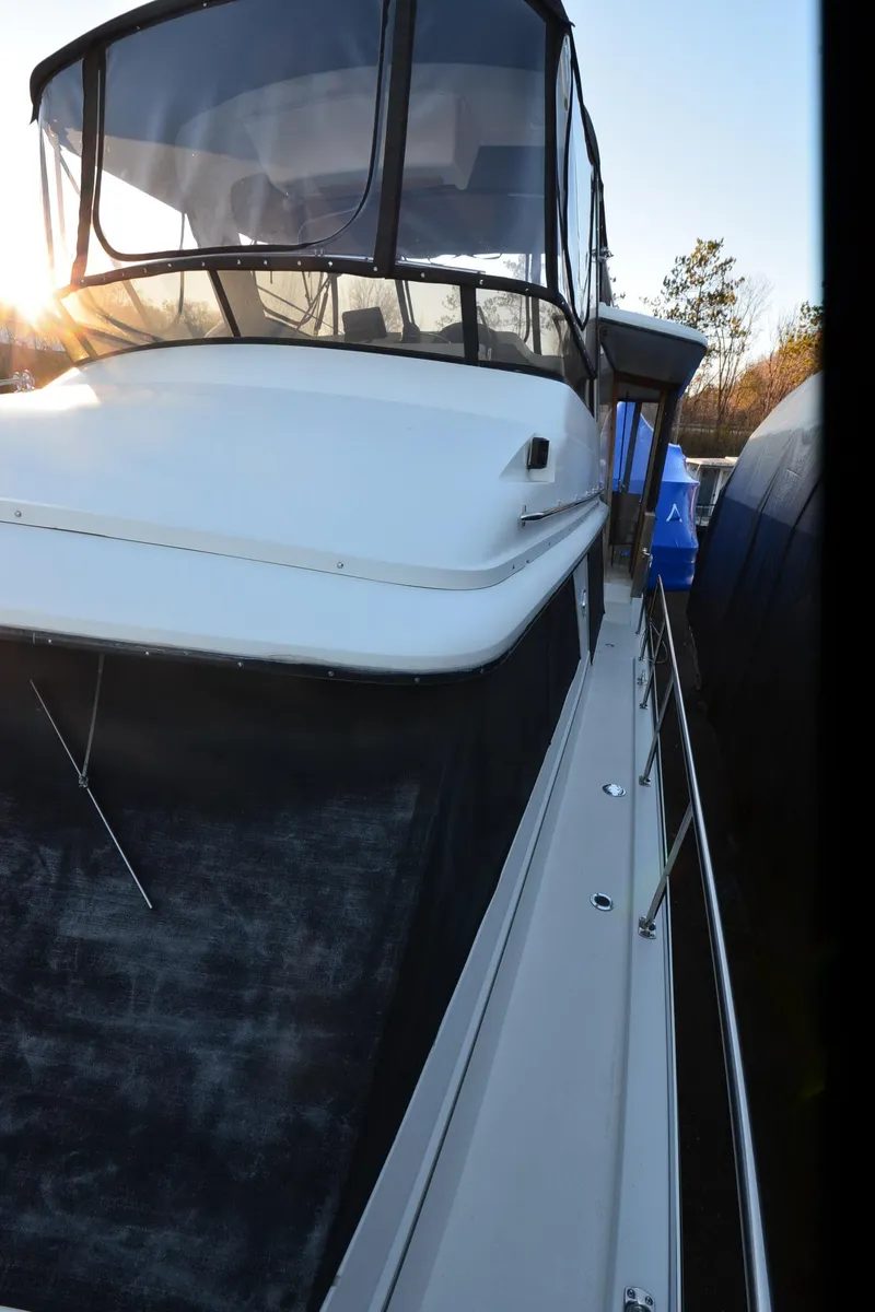 Slide: The Image of 1988 Carver 4207 Aft Cabin MY yacht, side view with sunlit cabin and sleek design. - 35