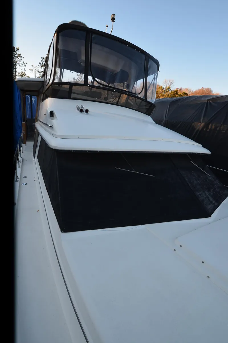 Slide: The Image of 1988 Carver 4207 Aft Cabin MY boat with enclosed flybridge, docked outdoors. - 38