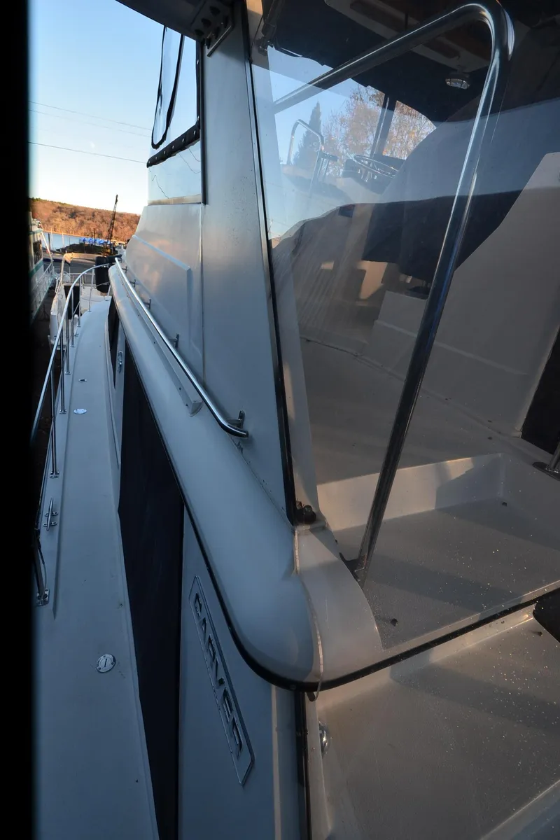 Slide: The Image of 1988 Carver 4207 Aft Cabin MY, side view with sleek design and railing details. - 39