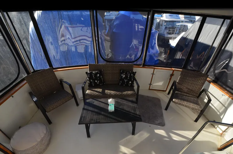 Slide: The Image of 1988 Carver 4207 Aft Cabin MY interior with seating area and table. - 5