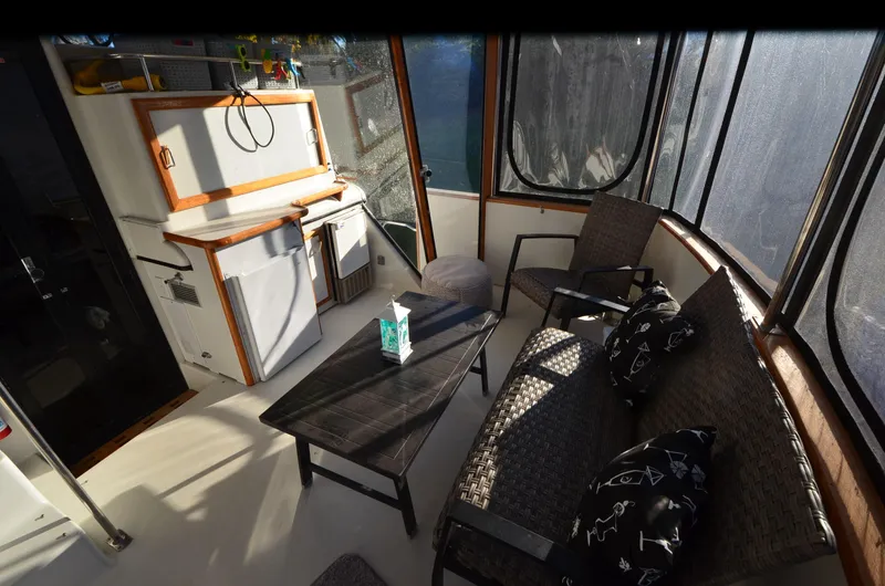 Slide: The Image of 1988 Carver 4207 Aft Cabin MY interior with seating, table, and kitchenette. - 6