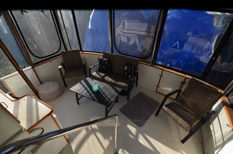 Slide: The Image of 1988 Carver 4207 Aft Cabin MY interior with seating area and table. - 7