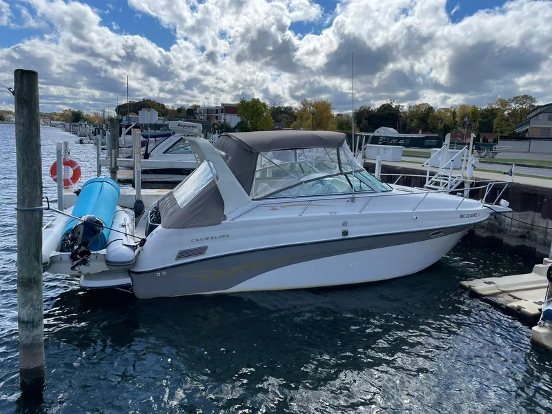 The Image of 2000 Crownline 290 CR boat docked at marina under cloudy sky. - 0
