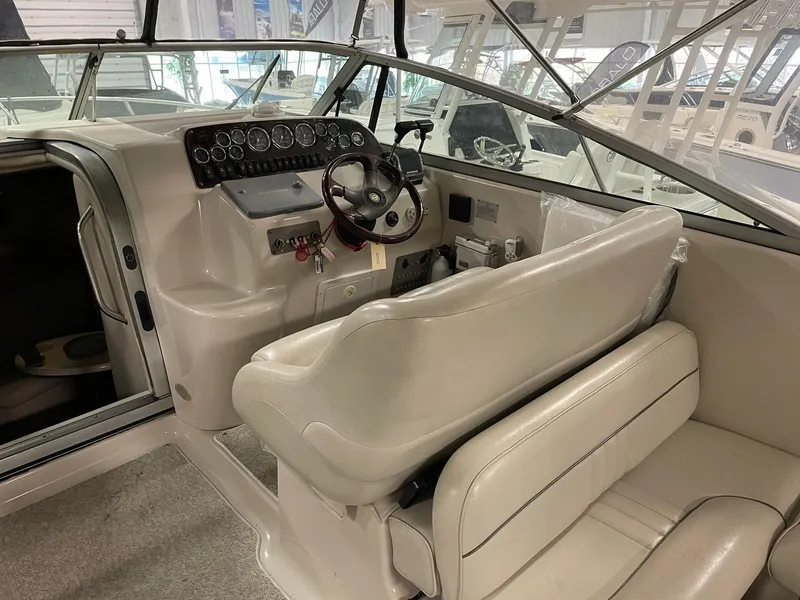 Slide: The Image of Crownline 290 CR 2000 boat interior with steering wheel and dashboard. - 13