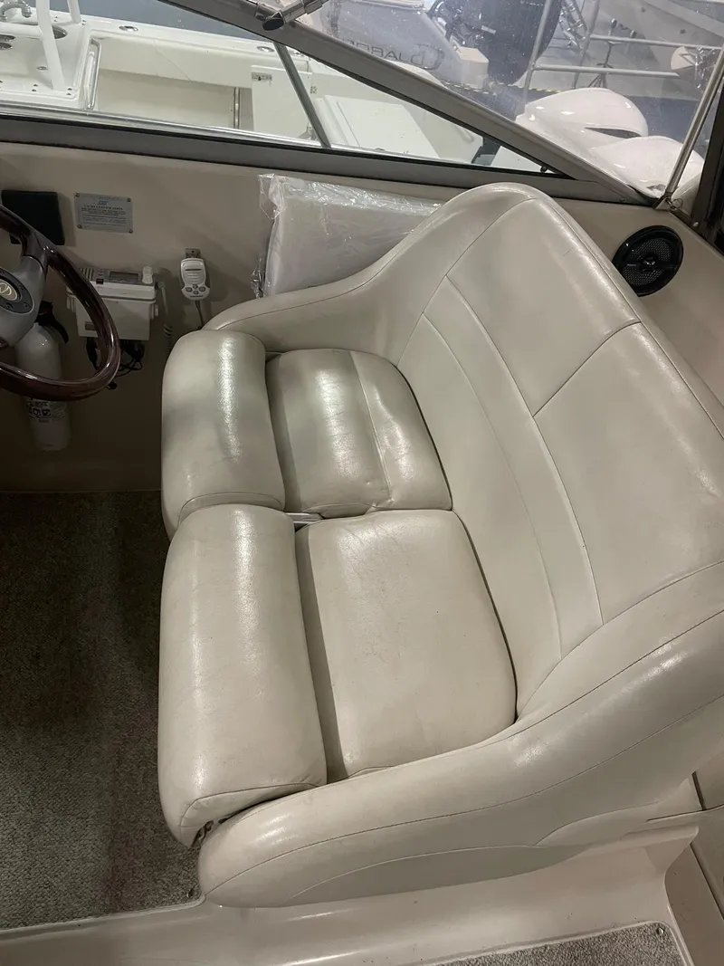 Slide: The Image of 2000 Crownline 290 CR boat interior with beige leather seating. - 14