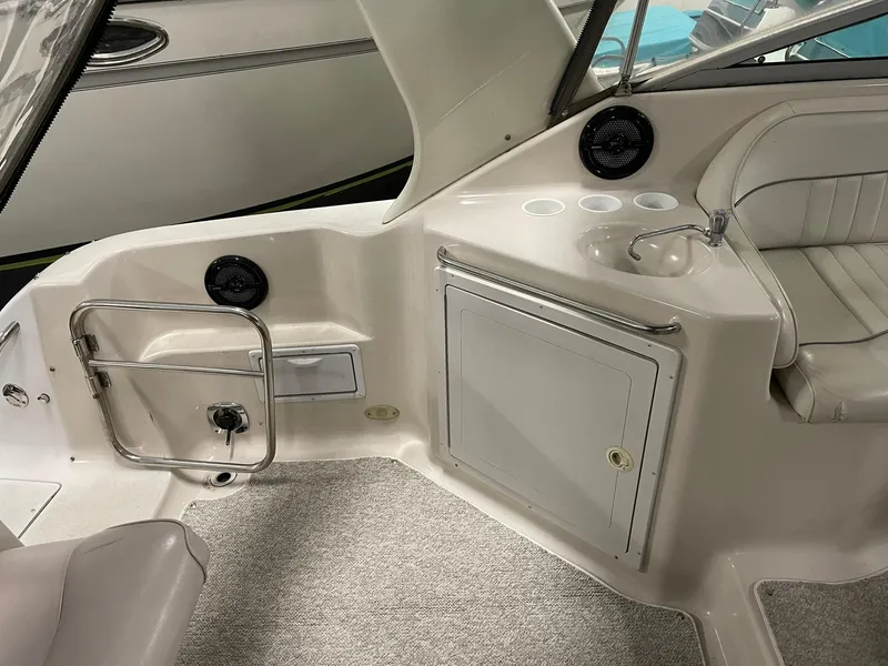 Slide: The Image of Interior of 2000 Crownline 290 CR boat with seating and sink area. - 15