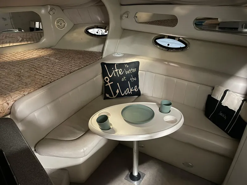 Slide: The Image of Cozy interior of 2000 Crownline 290 CR boat with dining area and decorative pillow. - 22