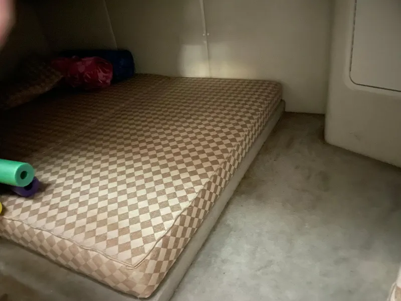 Slide: The Image of Interior cabin of 2000 Crownline 290 CR with checkered mattress. - 23