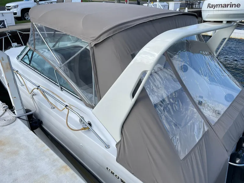 Slide: The Image of 2000 Crownline 290 CR boat with beige canopy docked at marina. - 3