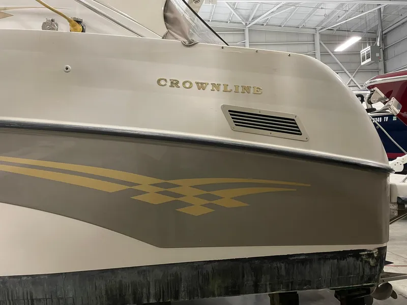 Slide: The Image of Crownline 290 CR 2000 boat in storage, showcasing sleek design and branding. - 7