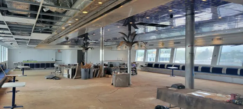 Slide: The Image of Spacious interior of 1981 Custom Victory 11 ship under renovation, featuring large windows and ceiling lights. - 10