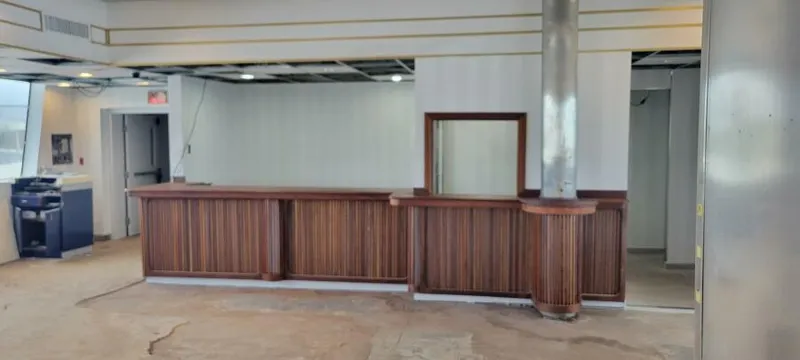 Slide: The Image of Empty room with wooden counter, exposed ceiling, and industrial design elements. - 13