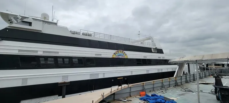 Slide: The Image of Custom Victory 11 ship docked, 1981 model, overcast sky. - 2