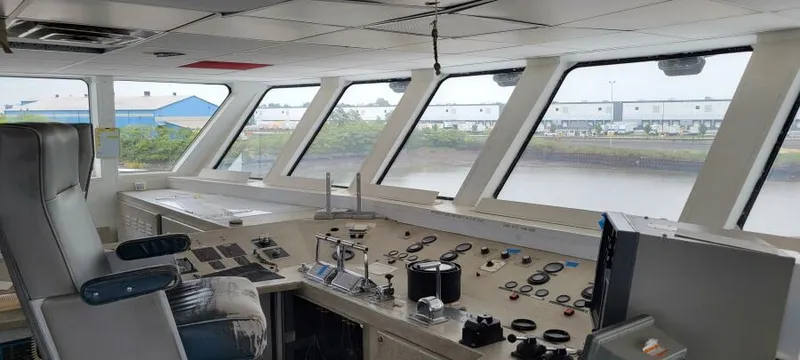 Slide: The Image of Interior of 1981 Custom Victory 11 ship's bridge with control panels and panoramic windows. - 4