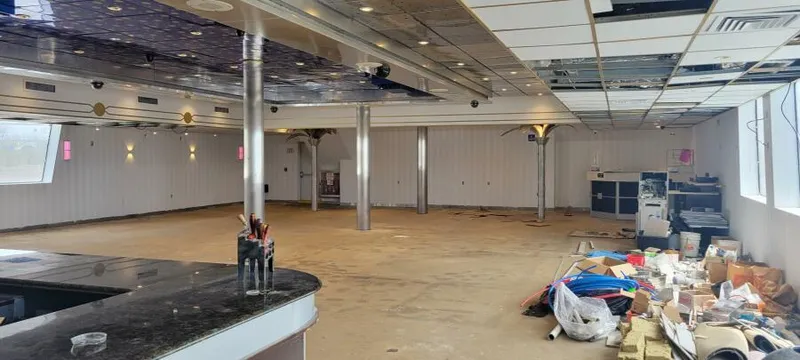 Slide: The Image of Spacious interior of a 1981 Custom Victory 11 ship, under renovation with scattered materials. - 9