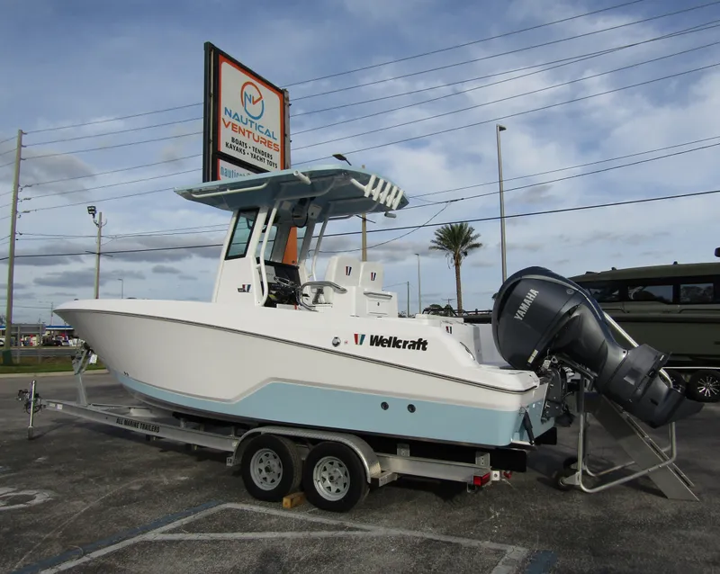 Slide: The Image of 2025 Wellcraft 243 Fisherman boat on trailer at dealership. - 2
