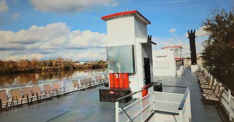 Slide: The Image of Vintage 1985 custom passenger boat deck with chairs, river view, and blue sky. - 4