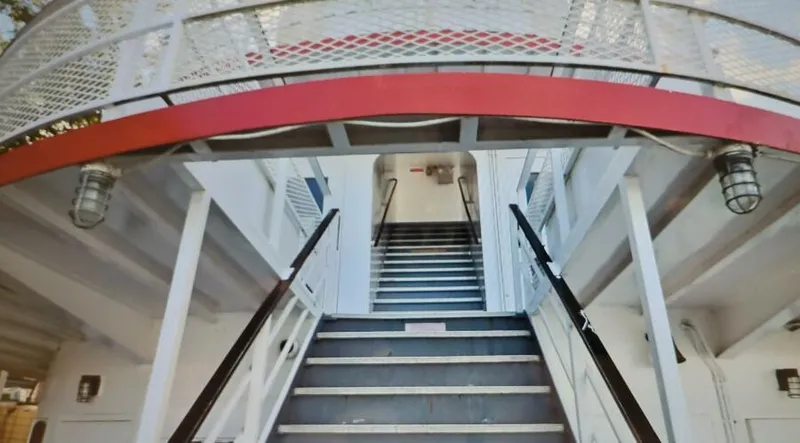 Slide: The Image of Staircase on 1985 custom dinner excursion passenger boat, featuring red and white design. - 6